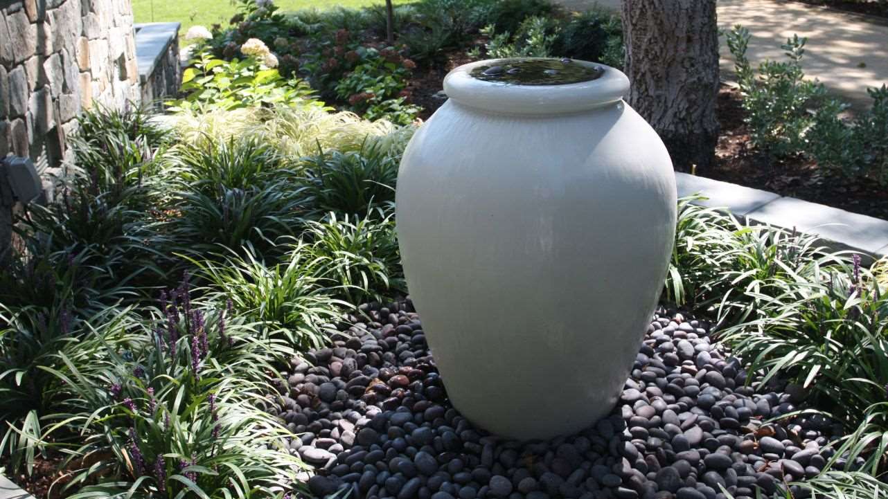 water feature urn in backyard renovation